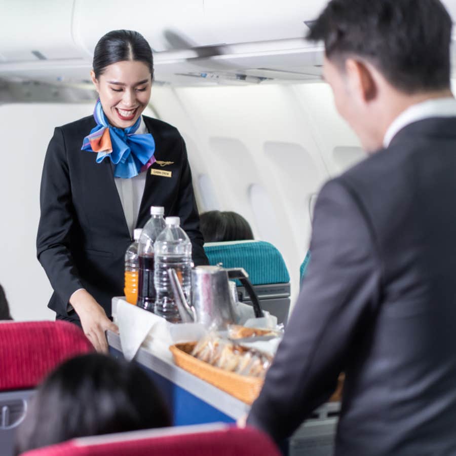 flight attendants working the service cart in flight