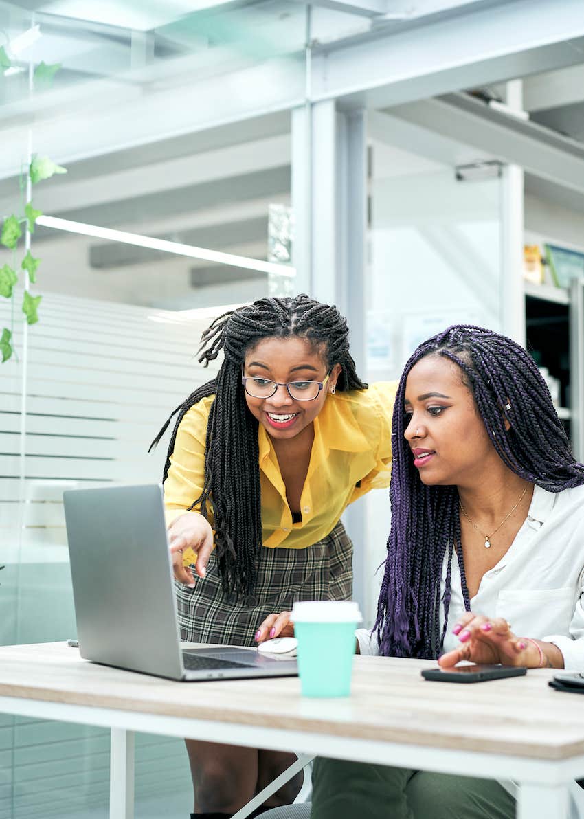 two business professionals help each other